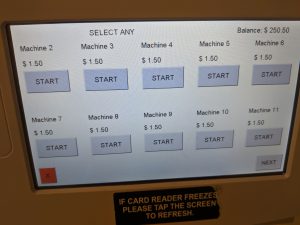 a touchscreen menu that displays which machines are available, with a start button for each machine located directly below the text